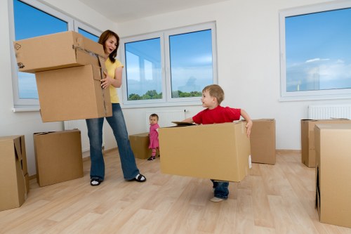 Workers using correct manual handling techniques with furniture