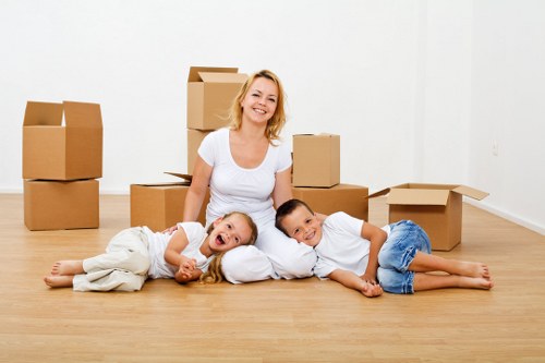 Packed household boxes and furniture ready for a home move in Brompton