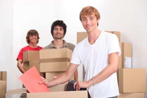 Skilled movers in Brompton wrapping fragile items with protective materials